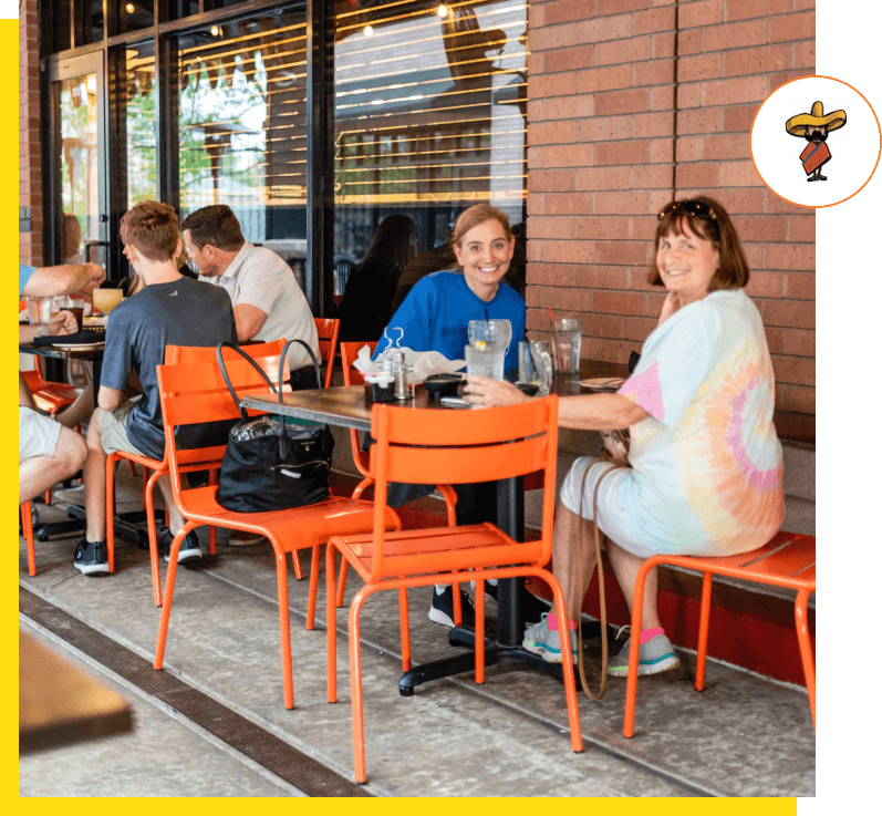 A group of people sitting at an outdoor cafe.